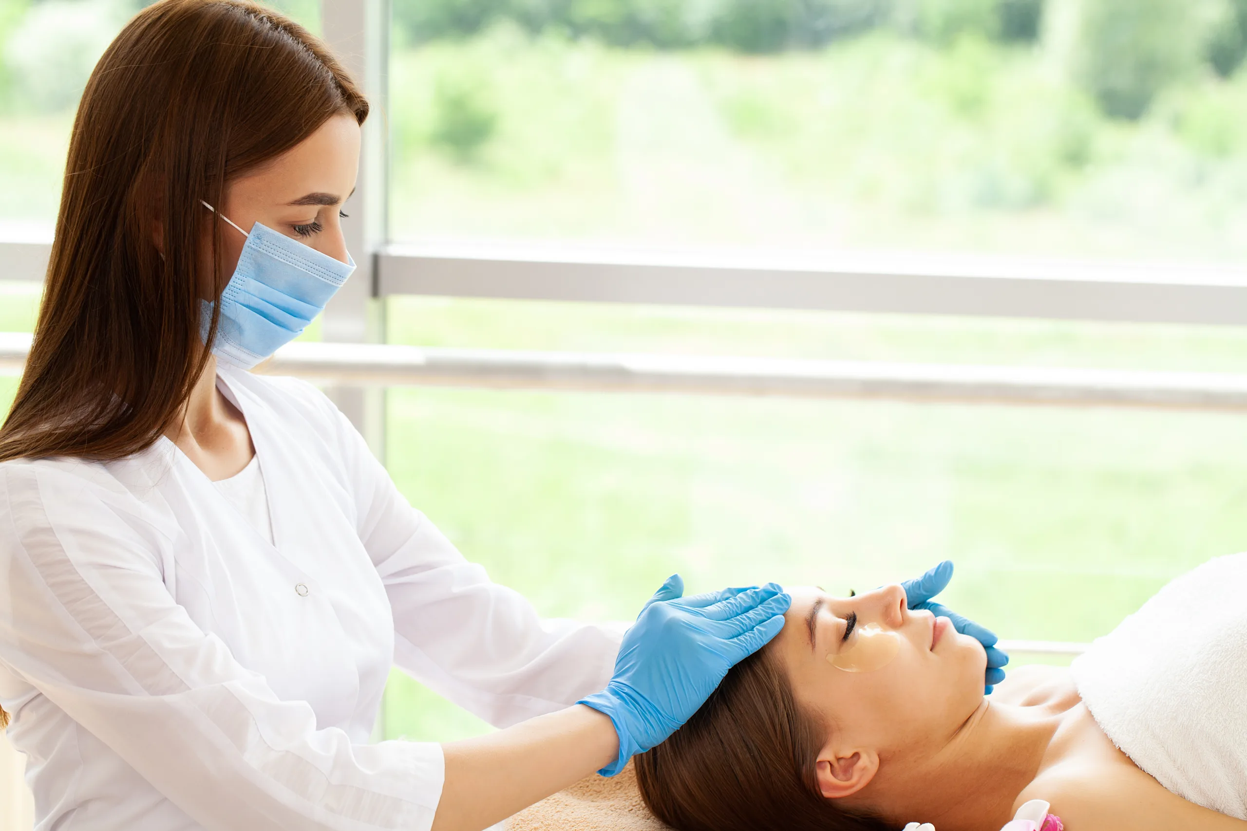 beautiful girl has facial massage beauty clinic scaled