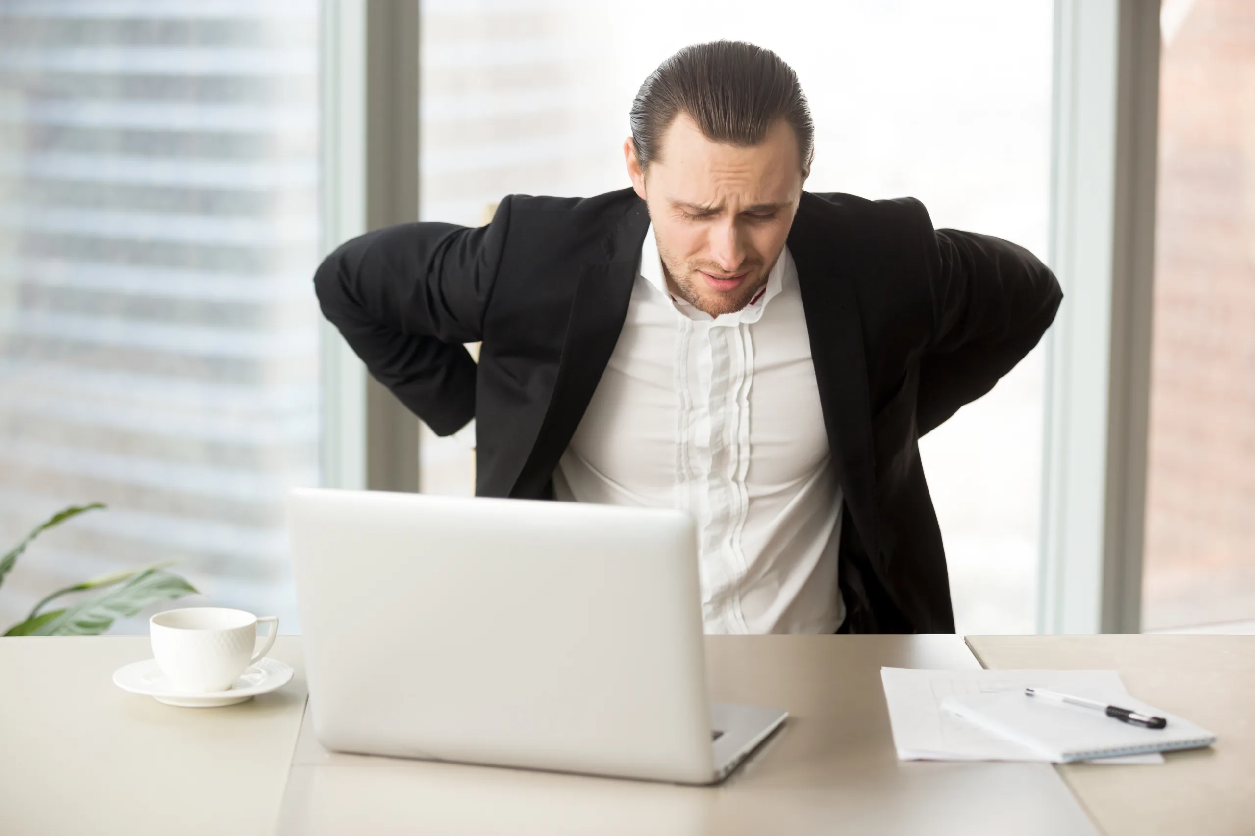 businessman suffering from backache workplace scaled