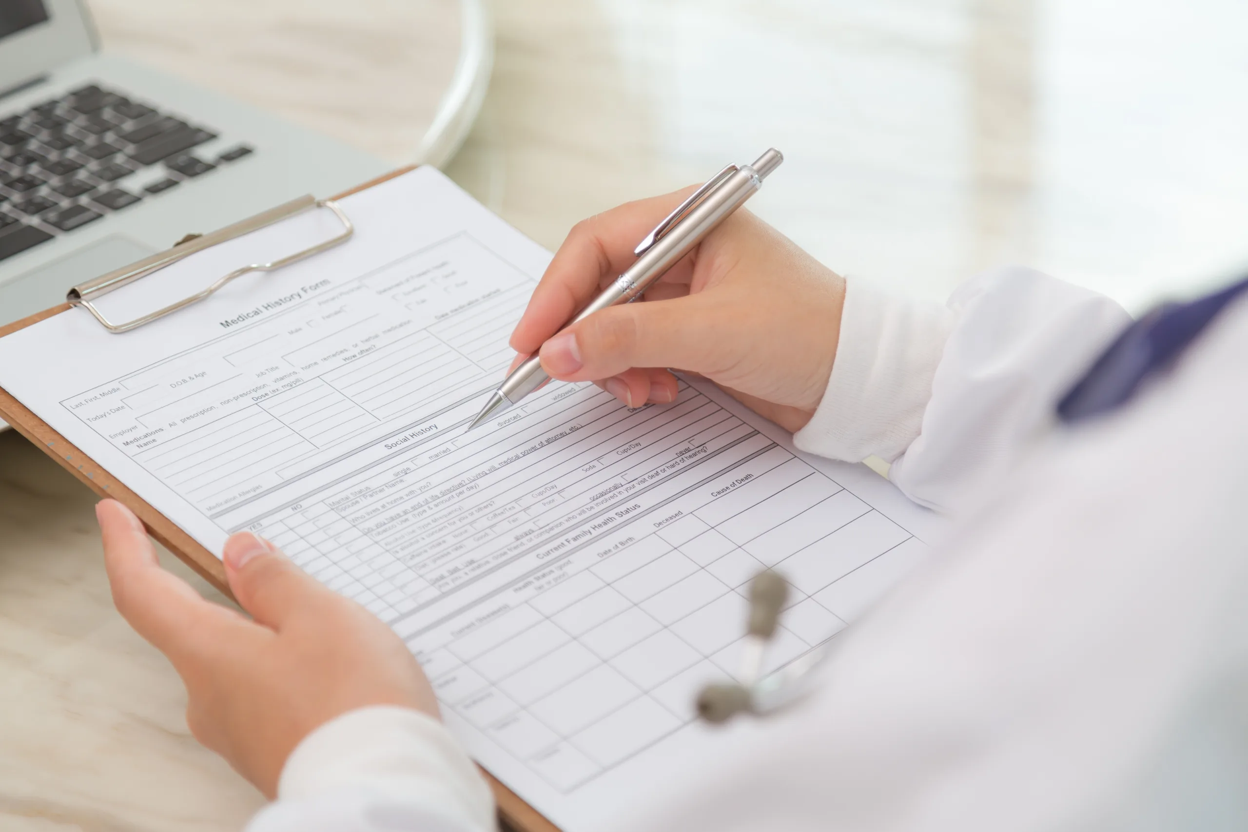 close up physician s hands with clipboard pen scaled