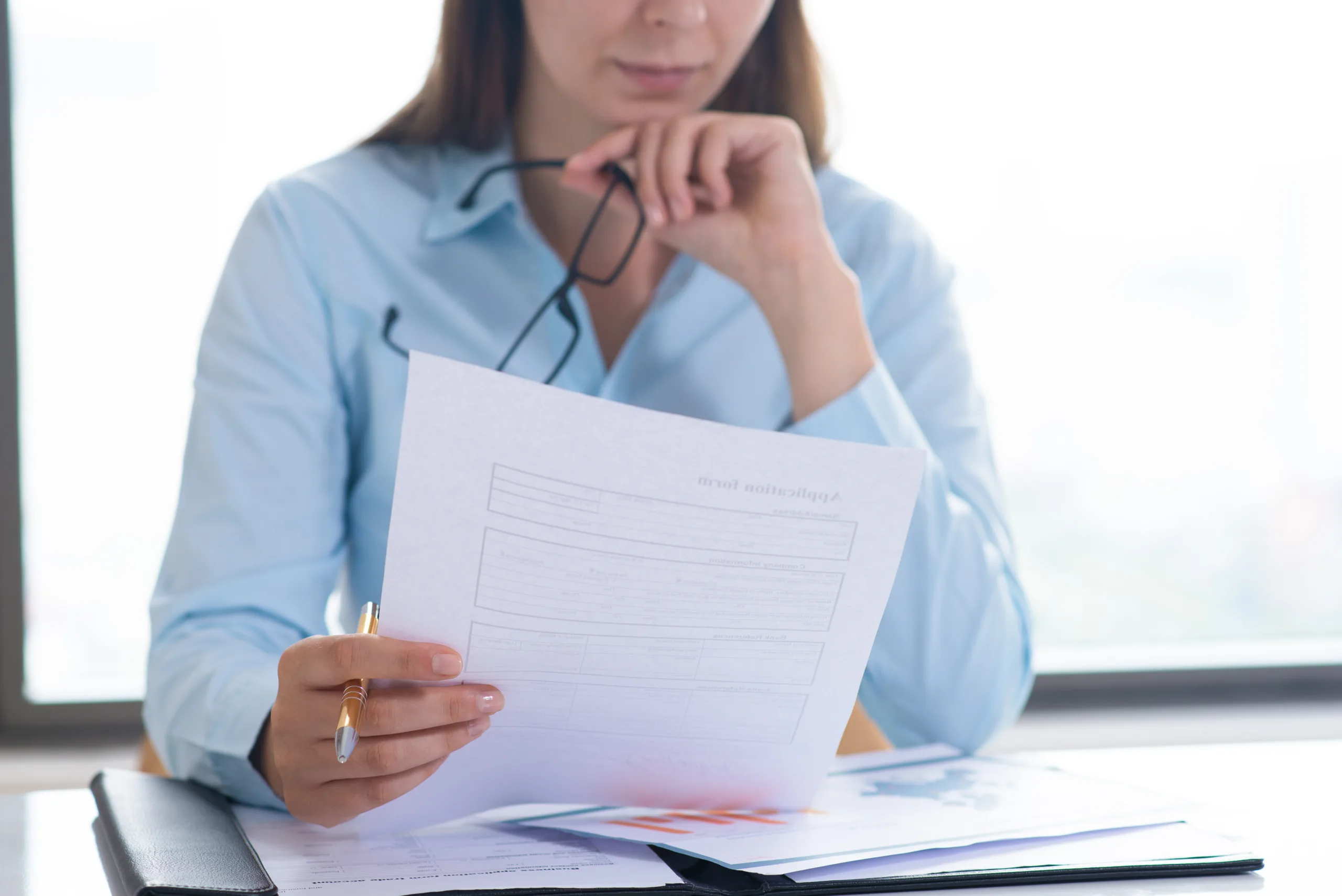 closeup woman holding reading document scaled