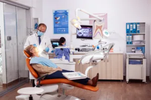 dentist doing dental treatment intervention senior woman elderly patient medical examination with dentist dental office with orange equipment