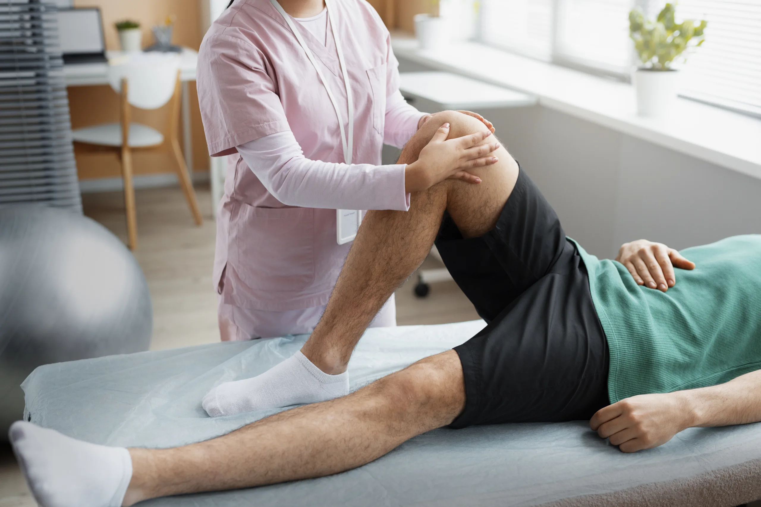 doctor helping patient rehabilitation scaled