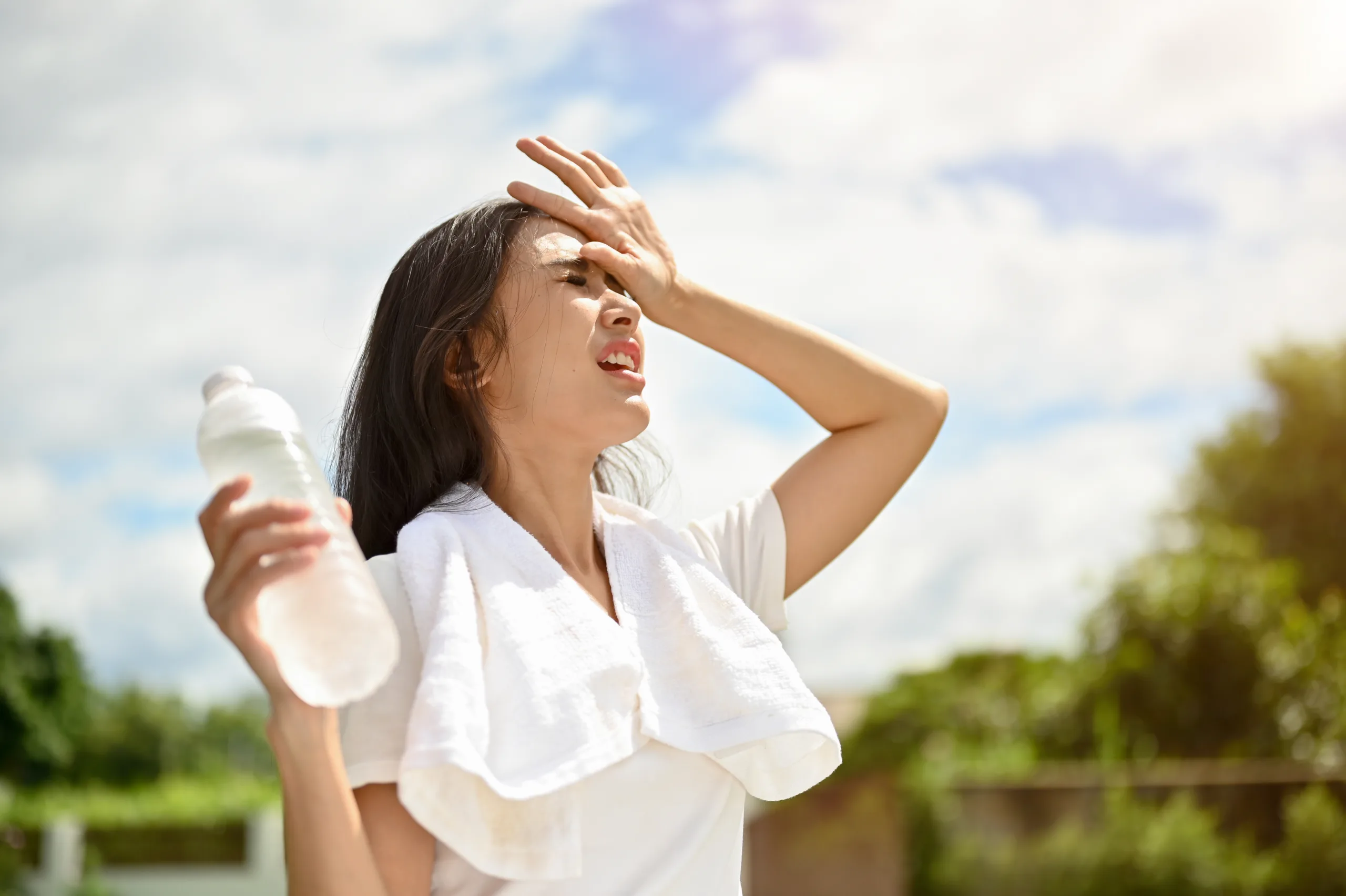 exhausted asian woman is fighting heat wave while running park sunny day scaled