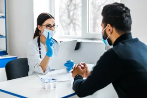 female doctor consults her patient holds documents her hands