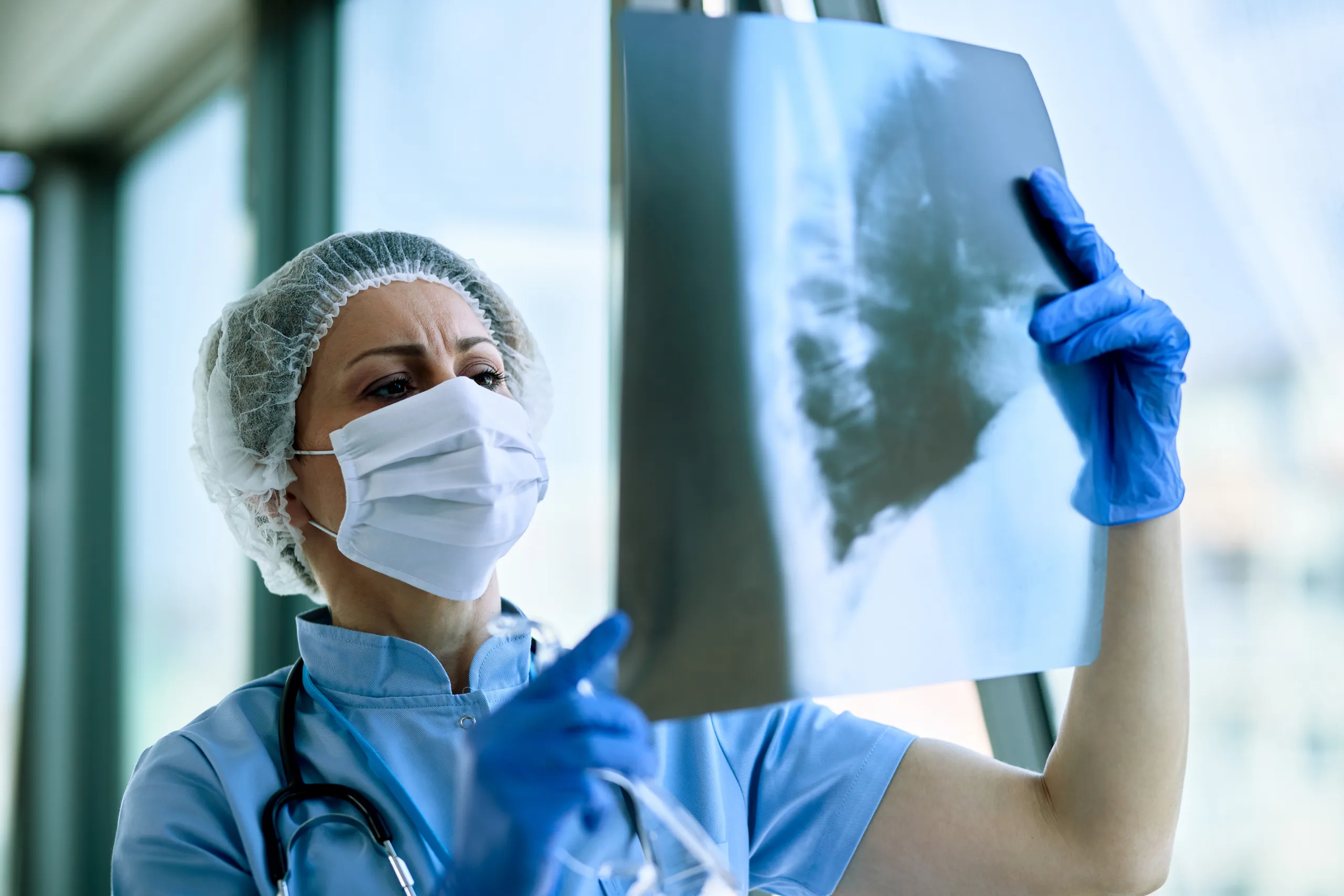female radiologist analyzing chest xray patient medical clinic coronavirus epidemic scaled
