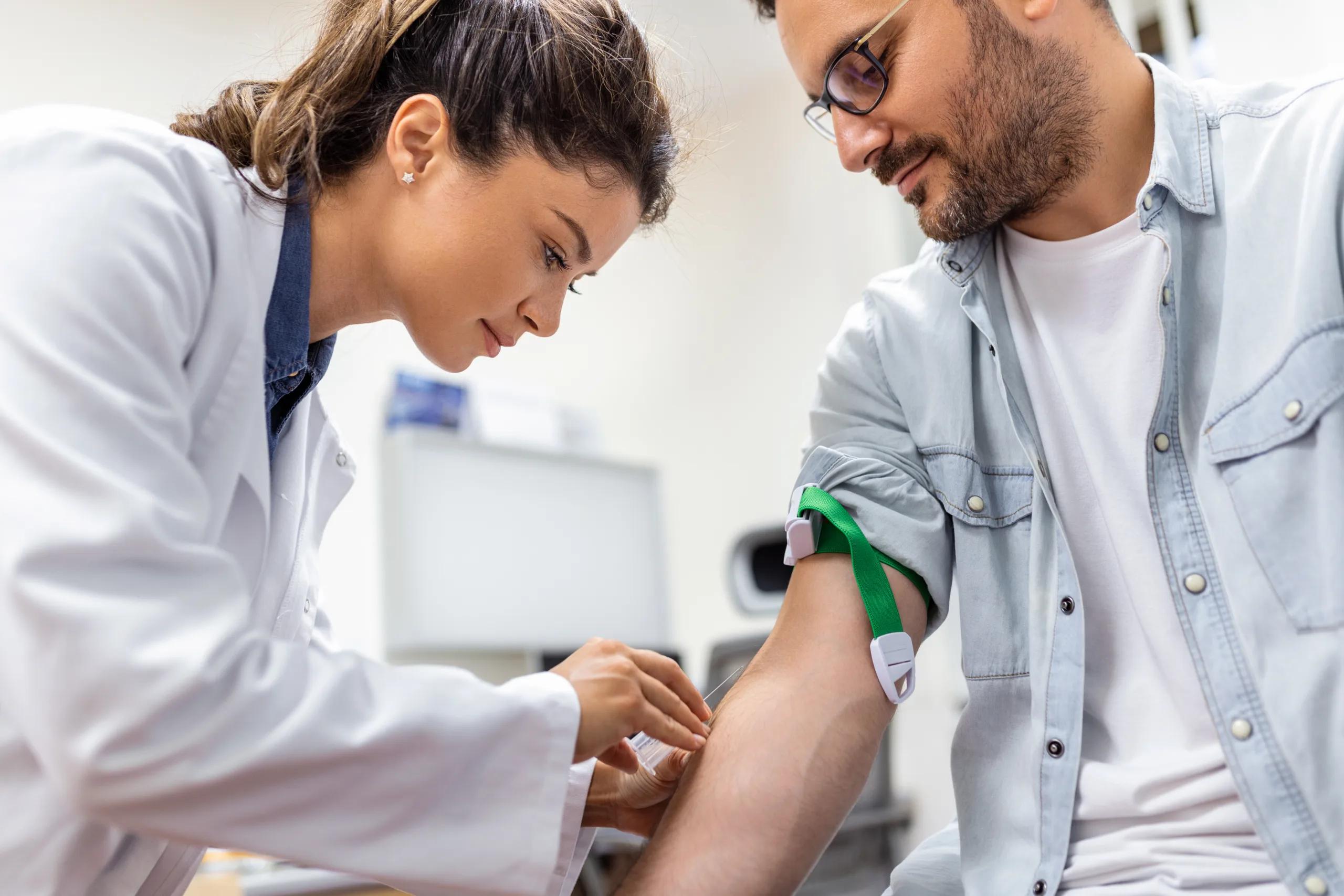 friendly hospital phlebotomist collecting blood sample from patient lab preparation blood test by female doctor medical uniform table white bright room scaled