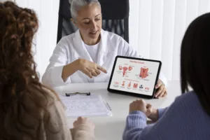 high angle doctor presenting with tablet