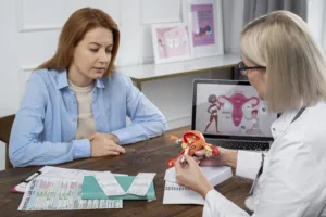 medium shot doctor explaining reproductive system model