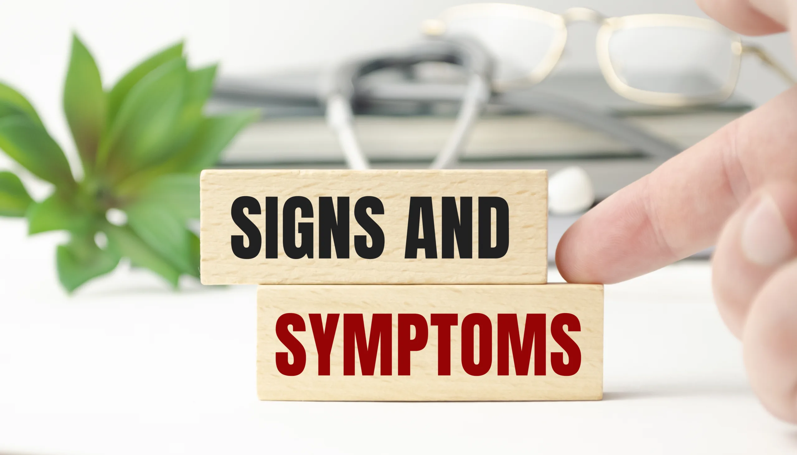 signs symptoms words wooden blocks stethoscope scaled