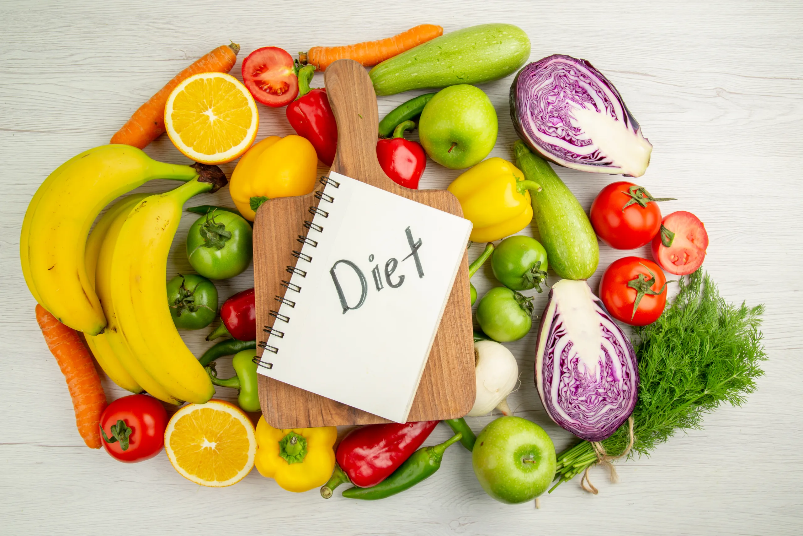 top view vegetable composition tomatoes cabbage bell peppers with bananas white background scaled