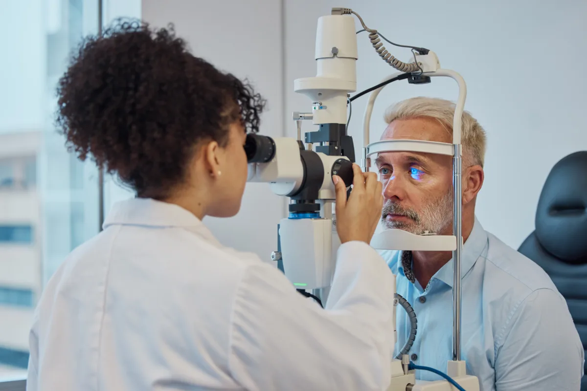 vision eye exam healthcare with doctor woman optometrist testing eyes man patient clinic hospital medical consulting with female eyesight specialist senior male