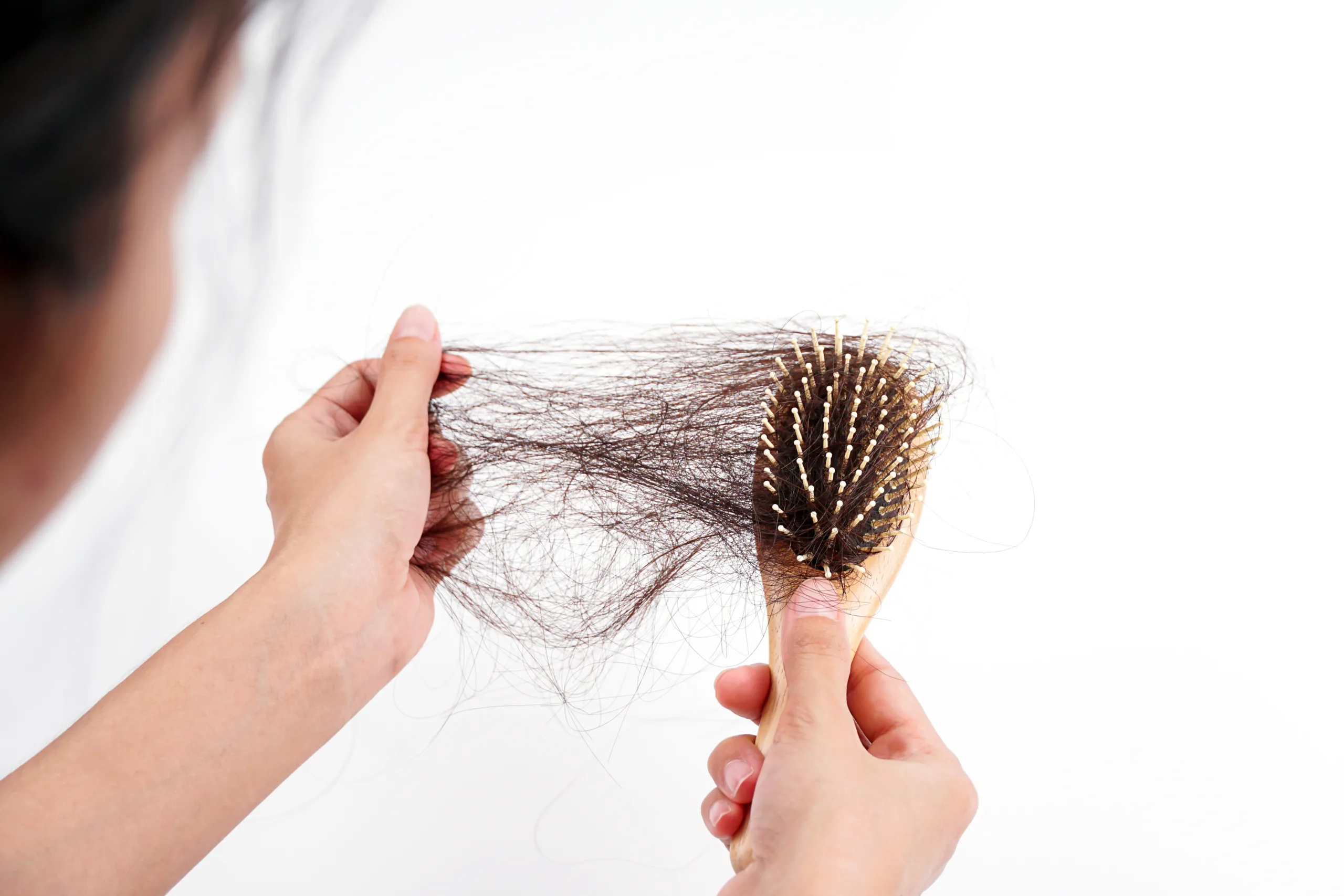 womans hand grabs missing hair brush isolated white background scaled