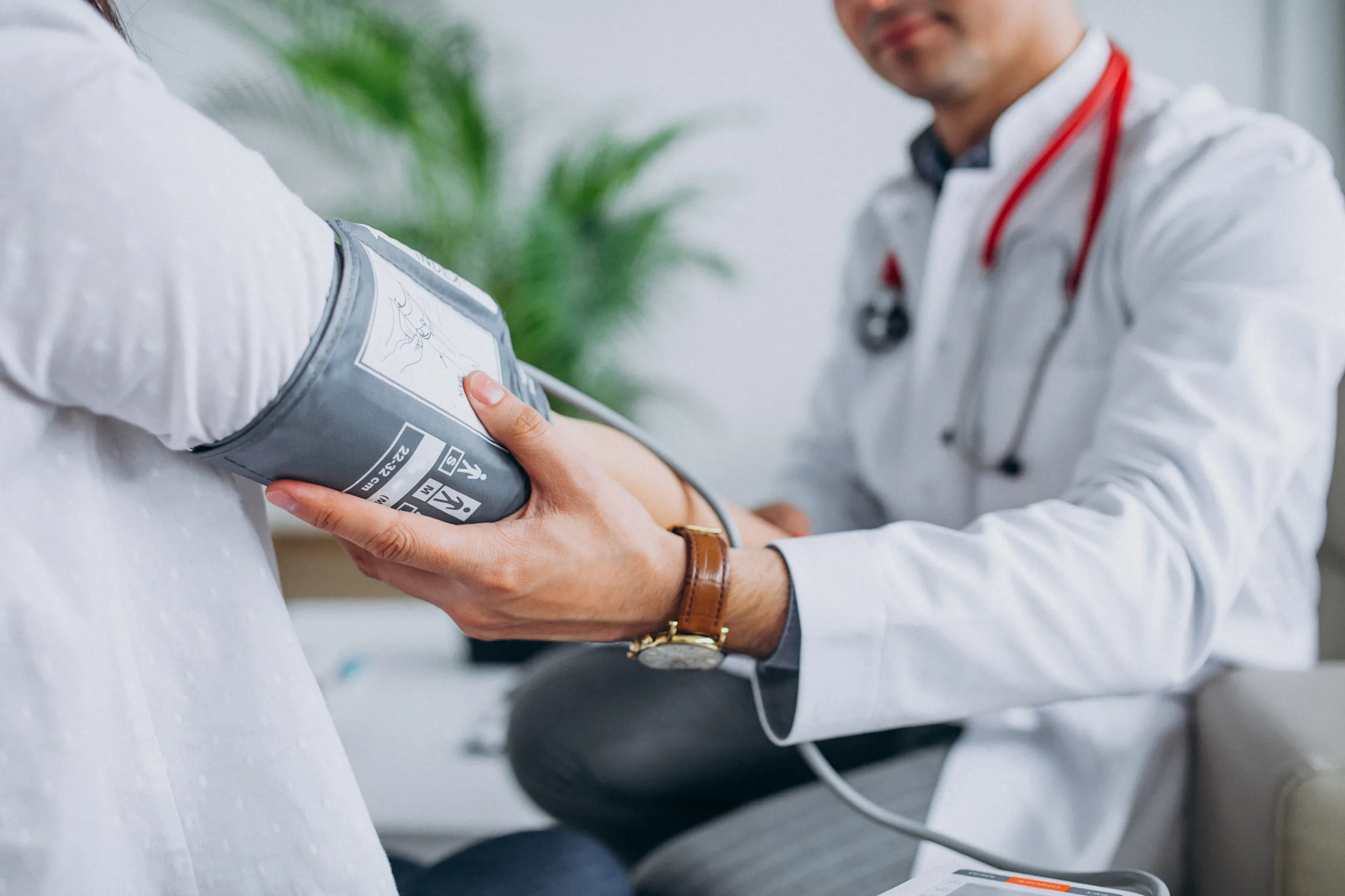 young male psysician with patient measuring blood pressure 1 1 scaled